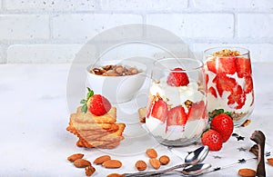Strawberry yogurt with berries, French cracker and granola on a bright table, fruit salad, detox diet
