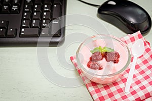 Strawberry yogurt on desk photo