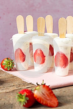 Strawberry yogurt ice cream popsicles. Healthy dessert. Homemade product. Summer background