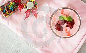 Strawberry yogurt with strawberry  on pink background. strawberry yoghurt. pink yogurt. strawberry in strawberry yogurt. heart in photo