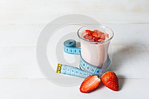 Strawberry yogurt smoothie with measure tape