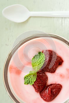 Strawberry yogurt with strawberry  on wooden. strawberry yoghurt. pink yogurt. strawberry in strawberry yogurt. heart in yogurt. photo