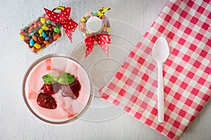 Strawberry yogurt with strawberry  on wooden. strawberry yoghurt. pink yogurt. strawberry in strawberry yogurt. heart in yogurt. photo