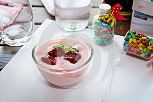 Strawberry yogurt with strawberry  on wooden. strawberry yoghurt. pink yogurt. strawberry in strawberry yogurt. heart in yogurt. photo