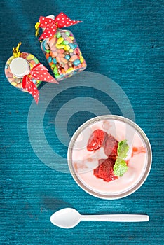Strawberry yogurt with strawberry . strawberry yoghurt. pink yogurt. strawberry in strawberry yogurt. heart in yogurt. heart. photo