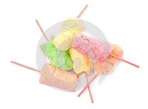 Straws with yummy cotton candy on white background