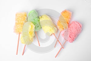 Straws with yummy cotton candy on white background