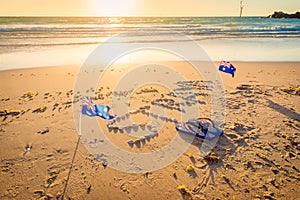 Straya text, flag and thongs on beach