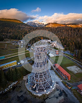 Strbske Pleso, Slovakia - Aerial panoramic view of the sightseeing tower by Strbske Lake with the High Tatras at background