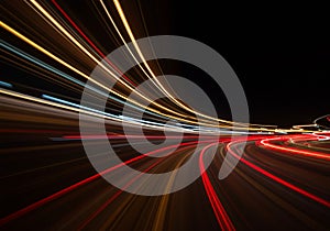 Streaks of multicolored light create dynamic curves against a dark