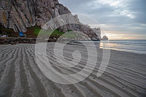 Streaky sand patterns at sunset at Morro Rock on the central coast of California at Morro Bay California USA