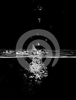 stream of bubbles under water on a black background