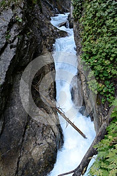 Stream in deep rocky ravine.