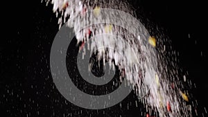 Stream of Falling Confetti, Dust Particles, and Snowfall on Black Background