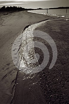 Stream flowing on beach