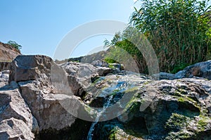 The stream flows down the granite stones on the riffles of the river, Ukraine