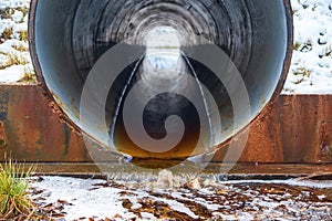 Stream in the pipe under the road