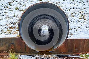 Stream in the pipe under the road