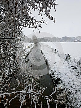 Snowy landscape with stream photo