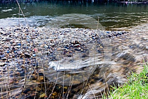 A stream joining the roch river and a rocky shore