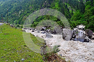 Stream meeting river Bhagirathi among Himalayan Mountains, Uttarakhand, India photo