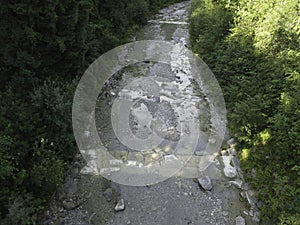 Stream in a natural area in Upper Bavaria with barrages and large stones at sunrise