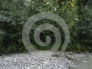 Stream in a natural area in Upper Bavaria with barrages and large stones at sunrise