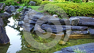 Stream of pure and fresh water that falls between the stones in a Japanese garden of Zen style.