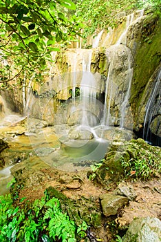 Stream rushing through cascade to emerald pond at Thac Voi waterfall, Thanh Hoa