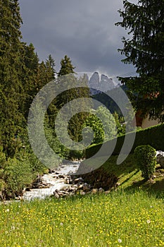 Stream in Santa Maddalena village.The Odle Group in background, Val di Funes, Dolomites, Italy, Europe.