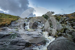 Stream with small waterfalls and cascades in Glendalough, Wicklow Mountains, Ireland