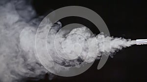 The stream of a smoke is blown from a tube. Soap bubbles show.