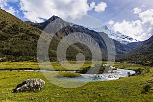 A stream and snow caped mountains in Huascaran National Park photo
