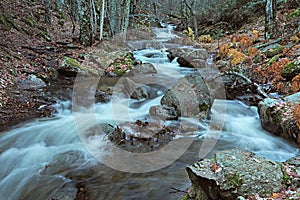 Stream with water effect moving in winter, Canencia, Madrid, Spain photo