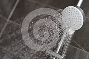 A stream of water is pouring from the shower head