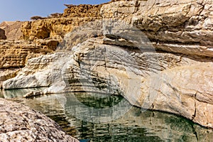 A stream of water in the rocky desert of Oman flowing in a canyon to the oasis of Wadi Bani Khalid - 4