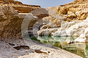 A stream of water in the rocky desert of Oman flowing in a canyon to the oasis of Wadi Bani Khalid - 5