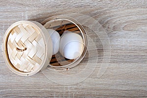 Streamed chinese buns, Dim Sum in round bamboo crate