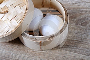 Streamed chinese buns, Dim Sum in round bamboo crate