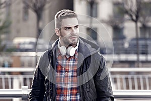 Streaming services concept. Modern people lifestyle. Handsome stylish man listen music outdoor. Guy enjoy music playing