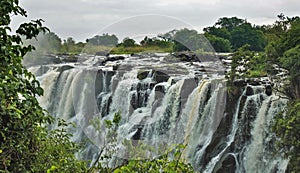 Streams of water cascade down the rocks into the gorge.