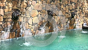 The streams of water are flowing into the pool , Bali, Indonesia