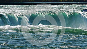 Streams of water of the mighty Niagara Falls. Pan shot