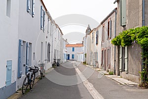 Street alley typical with bike bicycle front house white in island Noirmoutier Vendee France