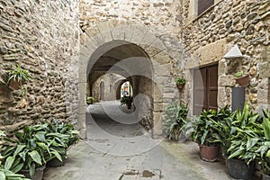 Street with arches in medieval village in Gerona, Monells, Catalonia, Spain photo