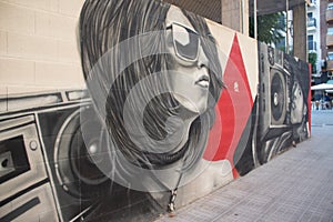 Street art graffiti of a girl listening to music