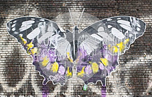 Street art in London:artwork representing a big butterfly on a brick wall.