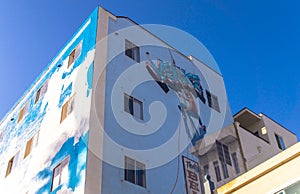 Street art at Venice Beach, Los Angeles, California. Colorful building with graffiti on blue sky background