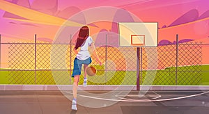 Street basketball court with girl player with ball