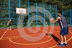 Street basketball players having training outdoor at court.